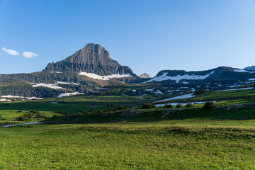 View from Logan Pass in Glacier National Park, Montana on a sunny summer evening, with glacial...