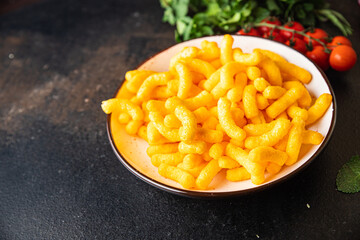 corn sticks bacon flavor cheetos fast food meal snack on the table copy space food background rustic. top view