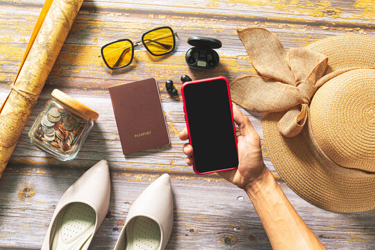 Plan a trip with a tablet,Plan a trip with a tablet,Packed suitcase of vacation items, top view,Tablet blank for mockup ecommerce concept with paying money by use credit card