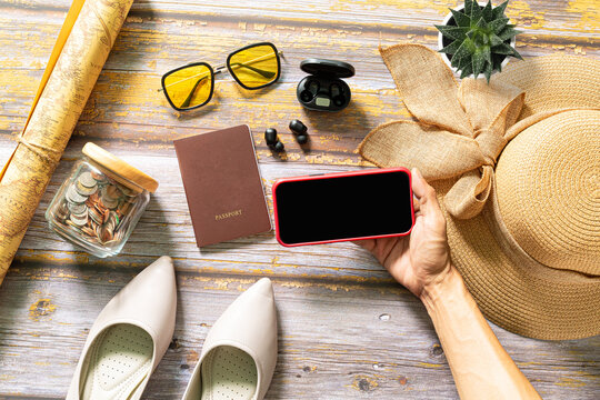 Plan a trip with a tablet,Plan a trip with a tablet,Packed suitcase of vacation items, top view,Tablet blank for mockup ecommerce concept with paying money by use credit card