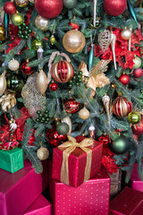 Stacks of Christmas presents under a Christmas tree