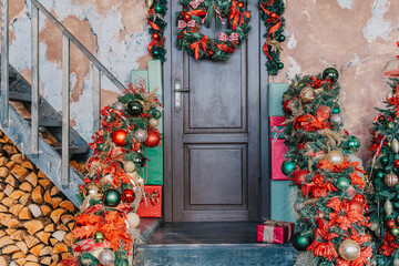 House entrance decorated for holidays. Christmas decoration. garland of fir tree branches