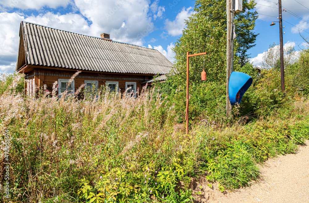 Wall mural Abandoned old rural wooden house in russian village