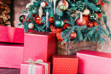 Stacks of Christmas presents under a Christmas tree