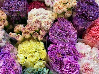 Yellow, purple and pink bouquets in the flower shop.