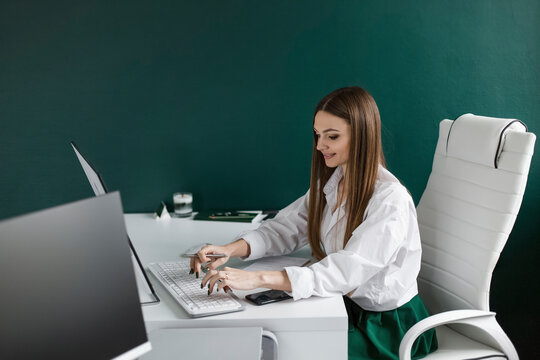 Businesswoman working on desktop computer at desk in office