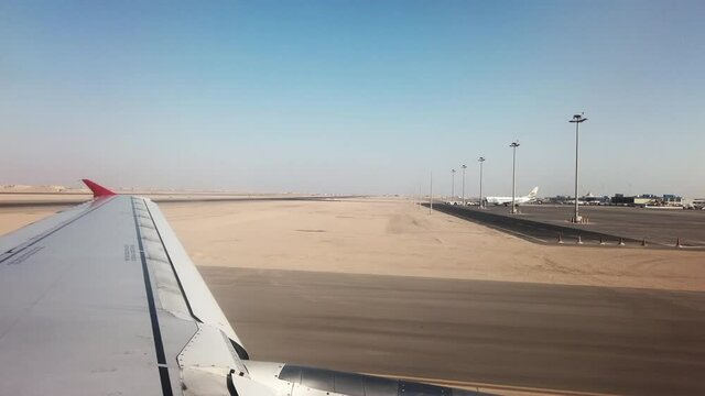 Airplane landing to airport runway in desert in Hurghada, Egypt