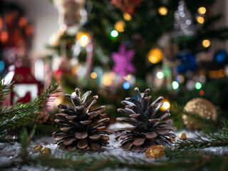 Pine cones with defocused lights in the background. Christmas card.