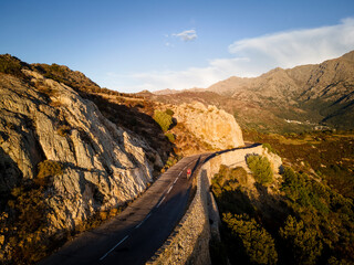 Athlete cycling on road by mountain