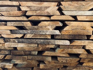 Stacked wooden boards. Side shot of wooden planks.