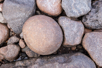 Stones of various sizes on the seashore. Background. Top view. 