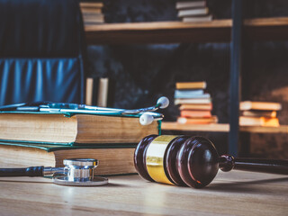 Medical negligence. Stethoscope on the book of laws and a gavel nearby.