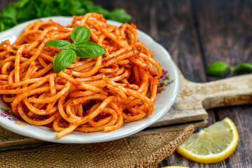 Spaghetti  bolognese .Italian home made meal Fresh  bucatini pasta with tomato sauce, basil, herbs ,parmesan cheese ,fresh cherry tomatoes and parsley on wooden background. Kitchen Poster 