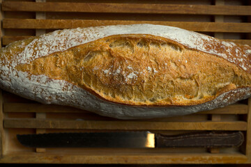 Artisan bread. Loaf of artisan bread on a wooden bread basket