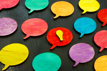 Colored quote bubbles and one with good idea as symbol of brainstorming and teamwork.