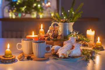 two cups of tea with homemade christmas baked goods on kitchen with christmas decoration