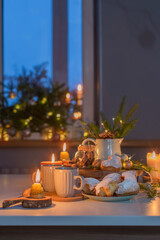 two cups of tea with homemade christmas baked goods on kitchen with christmas decoration