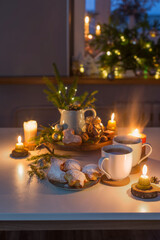 two cups of tea with homemade christmas baked goods on kitchen with christmas decoration
