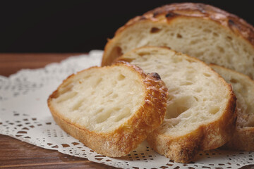 Close up of slices of freshly homemade wheat bread on napkin on table, selective focus.
