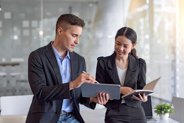 Two business people discuss investment project working and planning strategy. Businessman and...