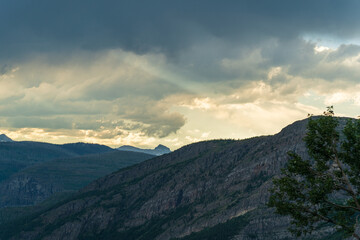 Golden hour, as viewed while driving on the Going to the Sun Road in Glacier National Park in...