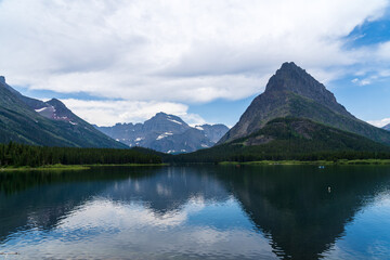 Fototapeta na wymiar Swiftcurrent Lake at Many Glacier in Glacier National Park in Montana on a cloudy summer day