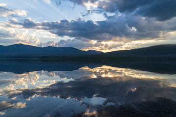 Reflection of the sunset over Lake McDonald in Glacier National Park in Montana