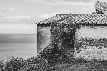 Black and white view of an old abandoned building in ruins on the Island of Gorgona, Livorno, Italy
