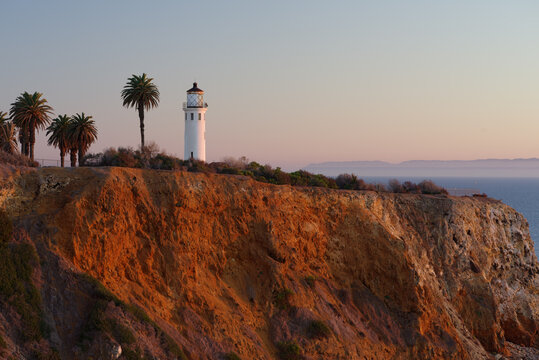 This image shows the Point Vicente Lighthouse in Rancho Palos Verdes at dusk. The Santa Catalina Island is shown in the background.