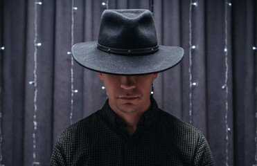 Image of an adult man wearing a black hat. Gangster concept.