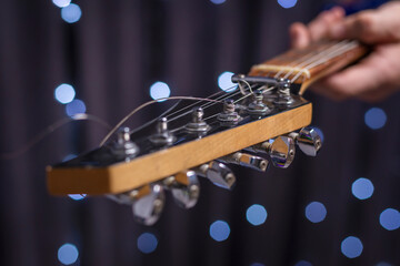Image of the strings of an electric guitar close-up. The concept of tuning and repairing musical...