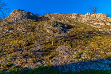 The view of the sides of the valley around the River Dove at Dovedale, UK on a sunny Autumn evening