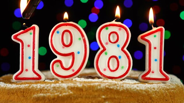Birthday cake with white burning candles in the form of number 1981