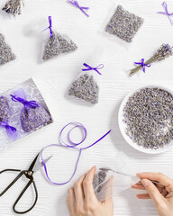 Woman hands hold scissor, make DIY lavender sachets for home,  natural scented bags from organza...