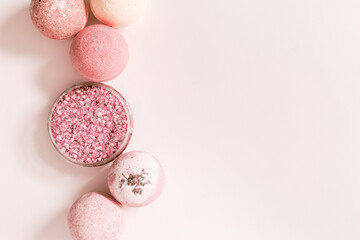 Pink bath bombs and sea salt with natural healthy ingredients, fragrant spa products with rose...