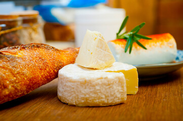 French cheese and fresh  baguette on a wood cutter