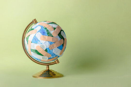 Globe of Planet Earth stuck with numerous band aids