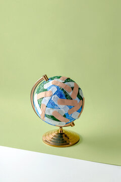 Globe of Planet Earth stuck with numerous band aids
