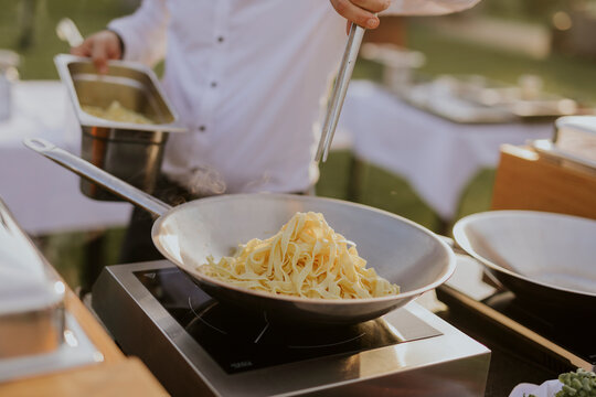 chef preparing pasta on a wedding