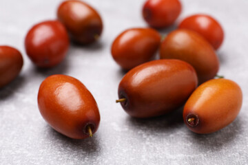 Fresh Ziziphus jujuba fruits on light table, closeup
