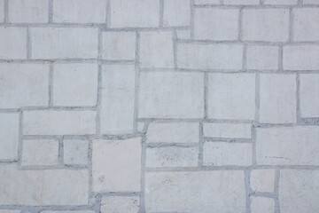 Texture of a stone. Old stone wall texture background. Grey stone wall as a background or texture. Stone wall of natural stones in different sizes. Side covering with natural stones.