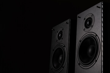 professional studio monitors with high sound quality, speaker system for music lovers on a black background - obrazy, fototapety, plakaty