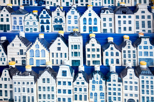 Famous souvenir - traditional blue porcelain houses background. European vintage Dutch houses in souvenir shop background.