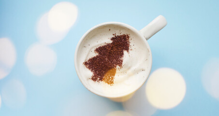 Top view Christmas tree drawing on coffee. Winter holidays hot chocolate banner. Festive glowing 