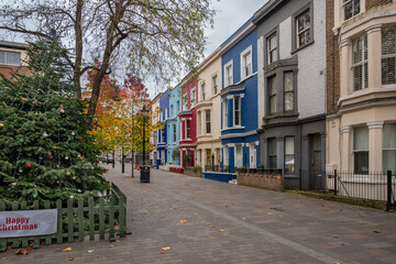 Fototapeta na wymiar Christmas tree and colorful facades at Noting Hill, London.