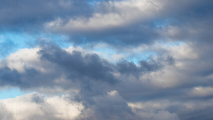 Fototapeta na wymiar Dark heavy clouds in the blue sky, dramatic sky with dark storm clouds