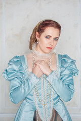 Sad Beautiful young woman in medieval style blue dress