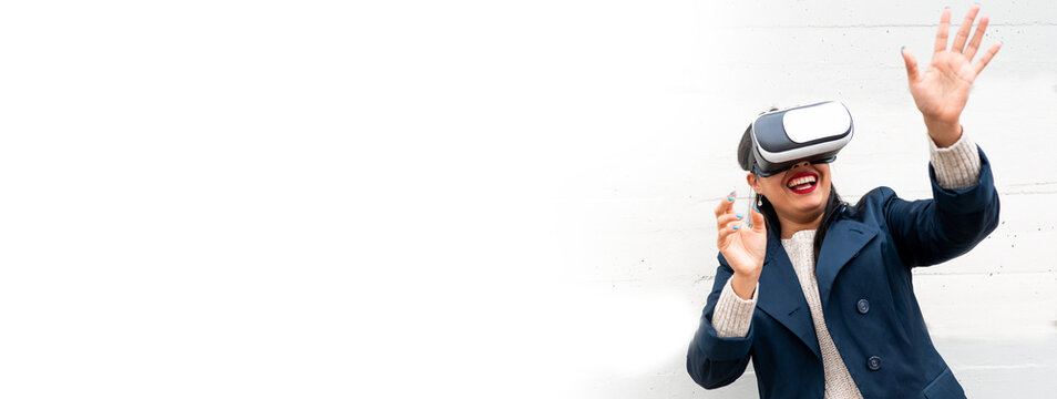Horizontal banner or header front view smiling woman wearing virtual reality headset and gesturing. Female in isolated white background.