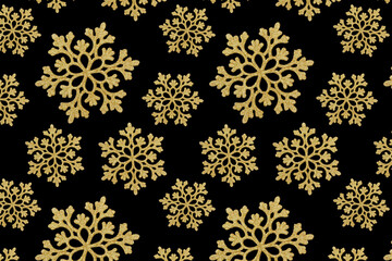 Seamless pattern. Golden snowflakes on a black background