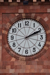 Fototapeta na wymiar Large white dial of the tower clock. Clock on a stone wall.